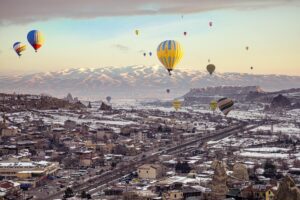 Hot Air Balloons Flying over City in Turkey by Arrange my tour